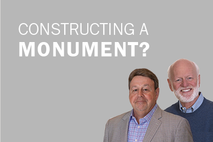 Sam Shriver and Marshall Goldsmith against gray backdrop; Constructing a Monument?