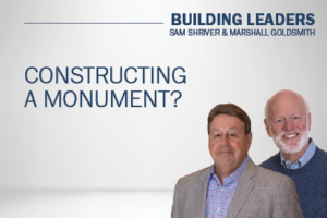 Sam Shriver and Marshall Goldsmith against gray backdrop; Constructing a Monument?