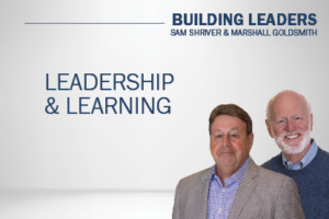Sam Shriver and Marshall Goldsmith against gray backdrop; Leadership and Learning