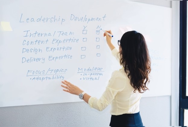 L&D professional writing on a white board