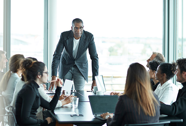 Business people in large modern meeting room