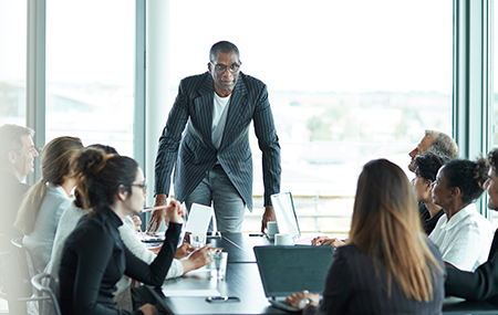 Business people in large modern meeting room
