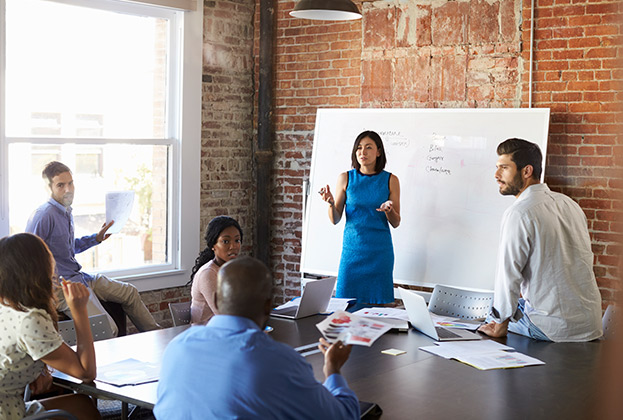 Businesswoman At Whiteboard In Brainstorming Meeting