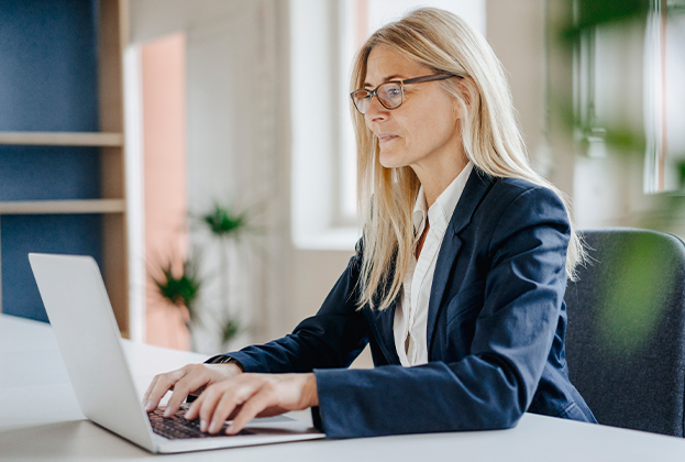 Businesswoman using laptop in office