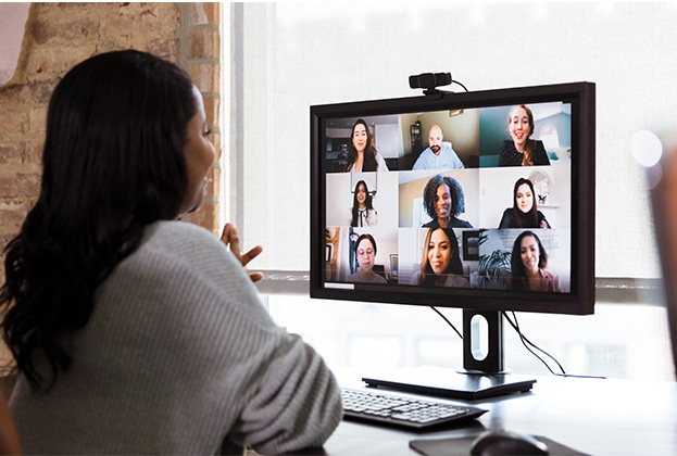 Businesswoman meeting with team of co-workers to discuss plans