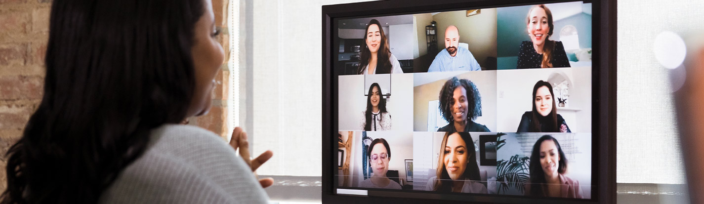 Businesswoman meeting with team of co-workers to discuss plans