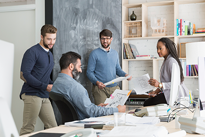 Happy coworkers meeting in open plan office