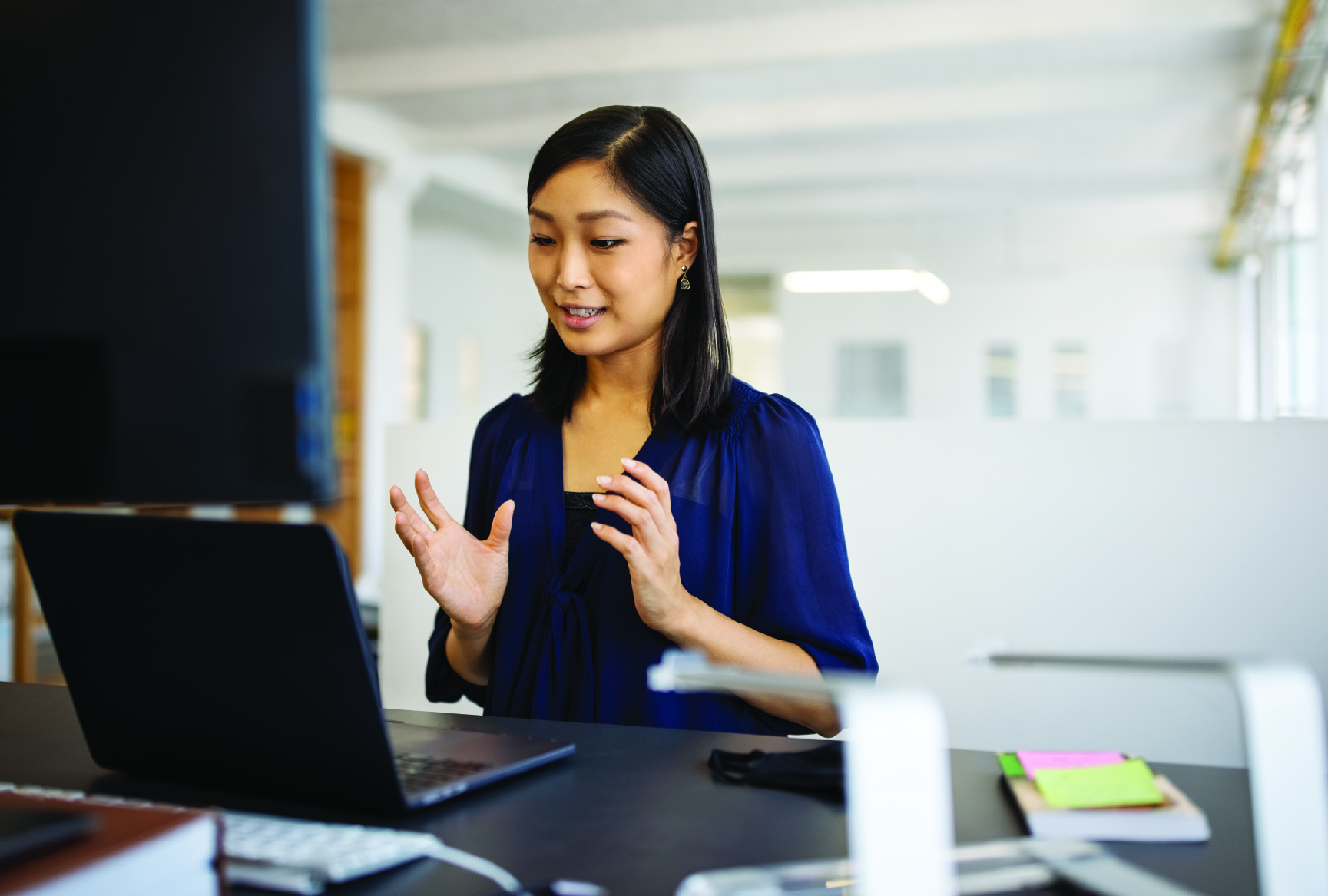 Business Woman at the office speaking to computer screen