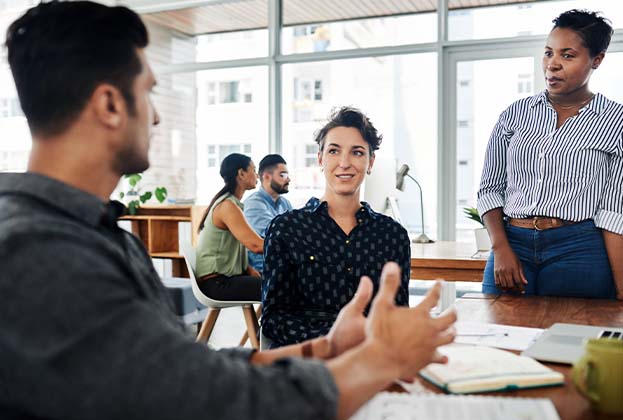 Shot of a group of young businesspeople sharing ideas with each other in a modern office