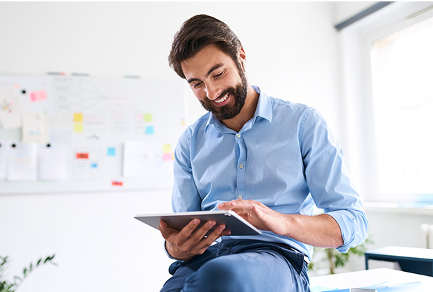 Businessman reading his assessment results on a digital tablet in his office