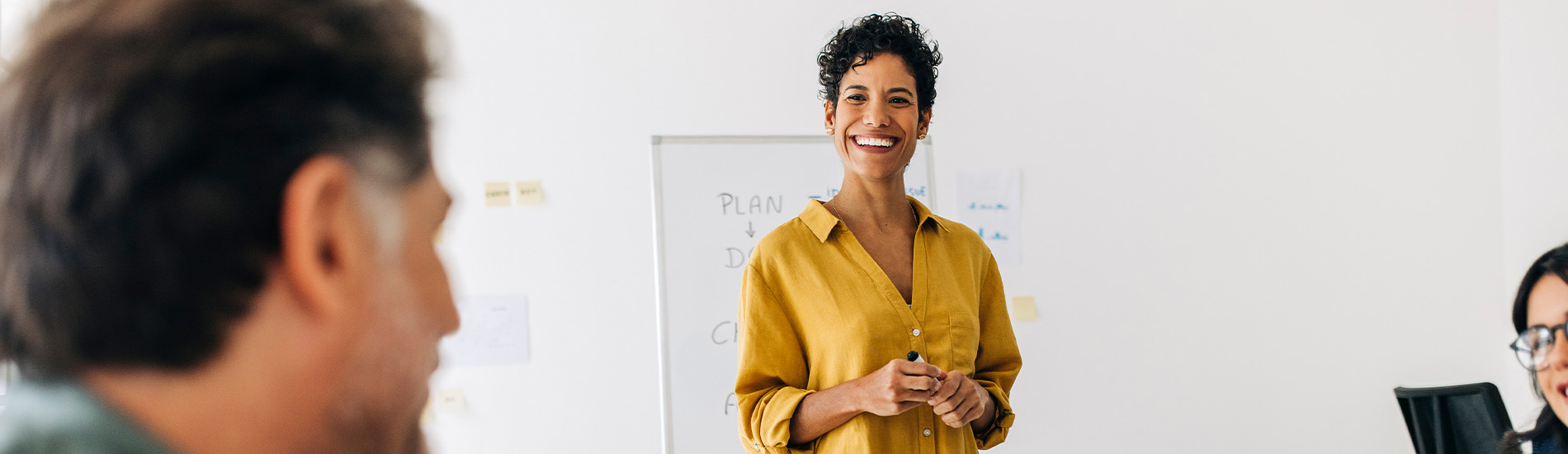 Businesswoman presenting to a group of colleagues.